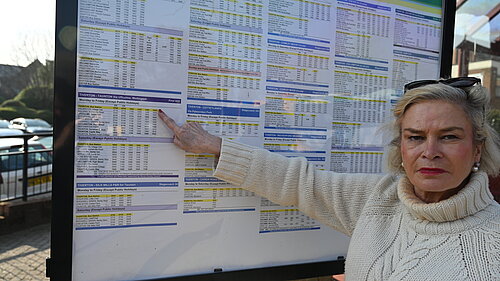 Rachel with bus timetable